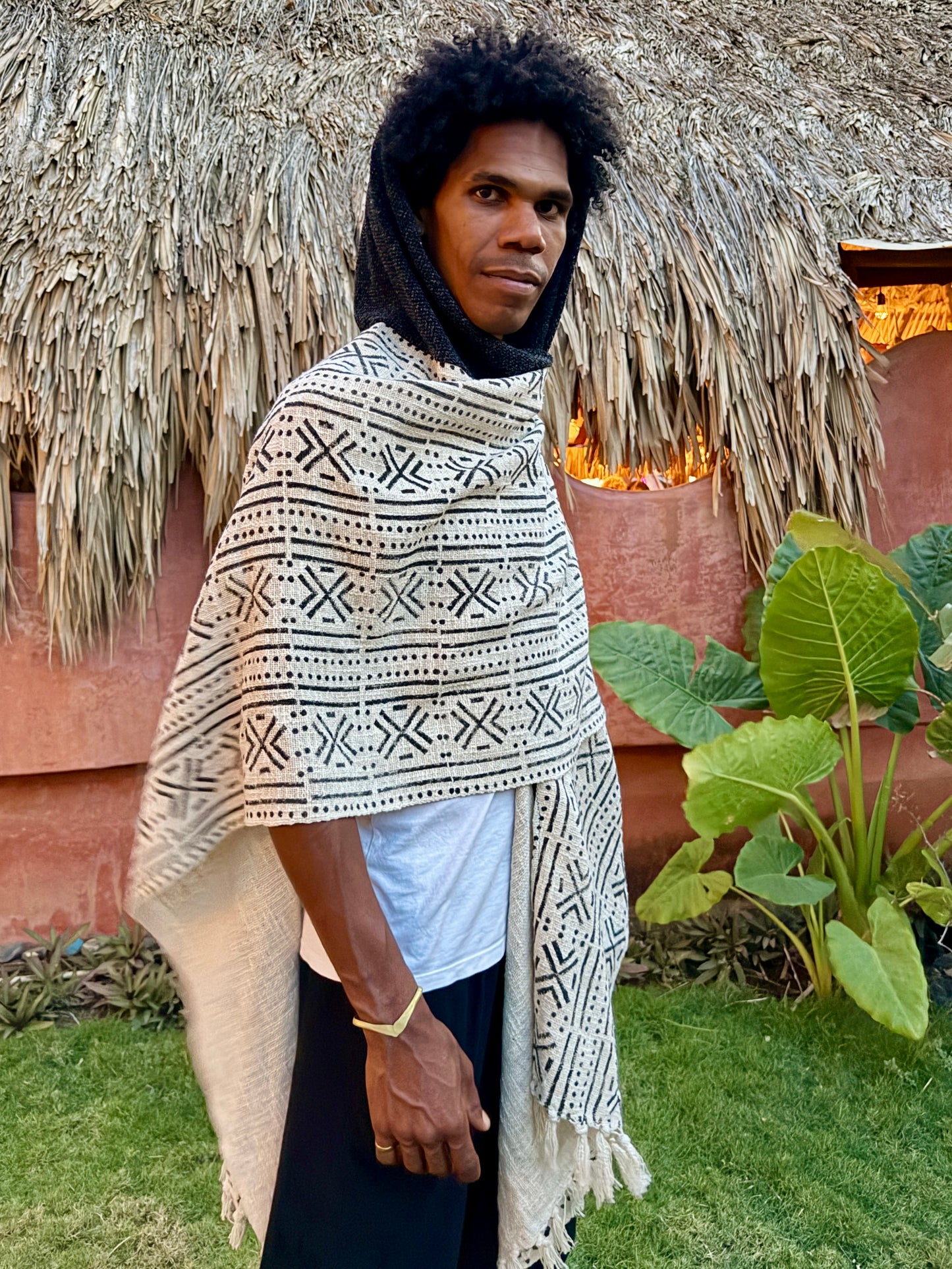 a man standing in glorka handblock printed poncho with dark gray hood