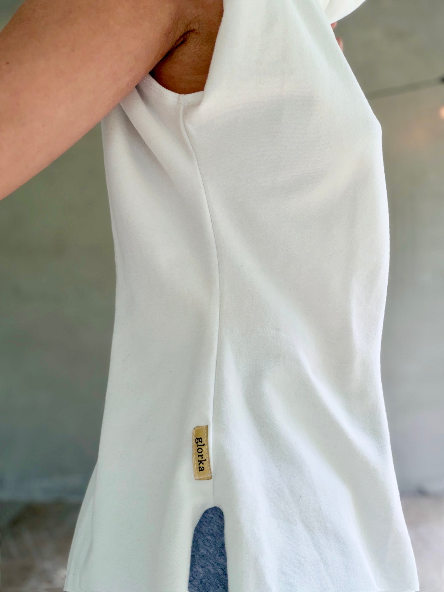 Female model wearing glorka white top with turtle neck