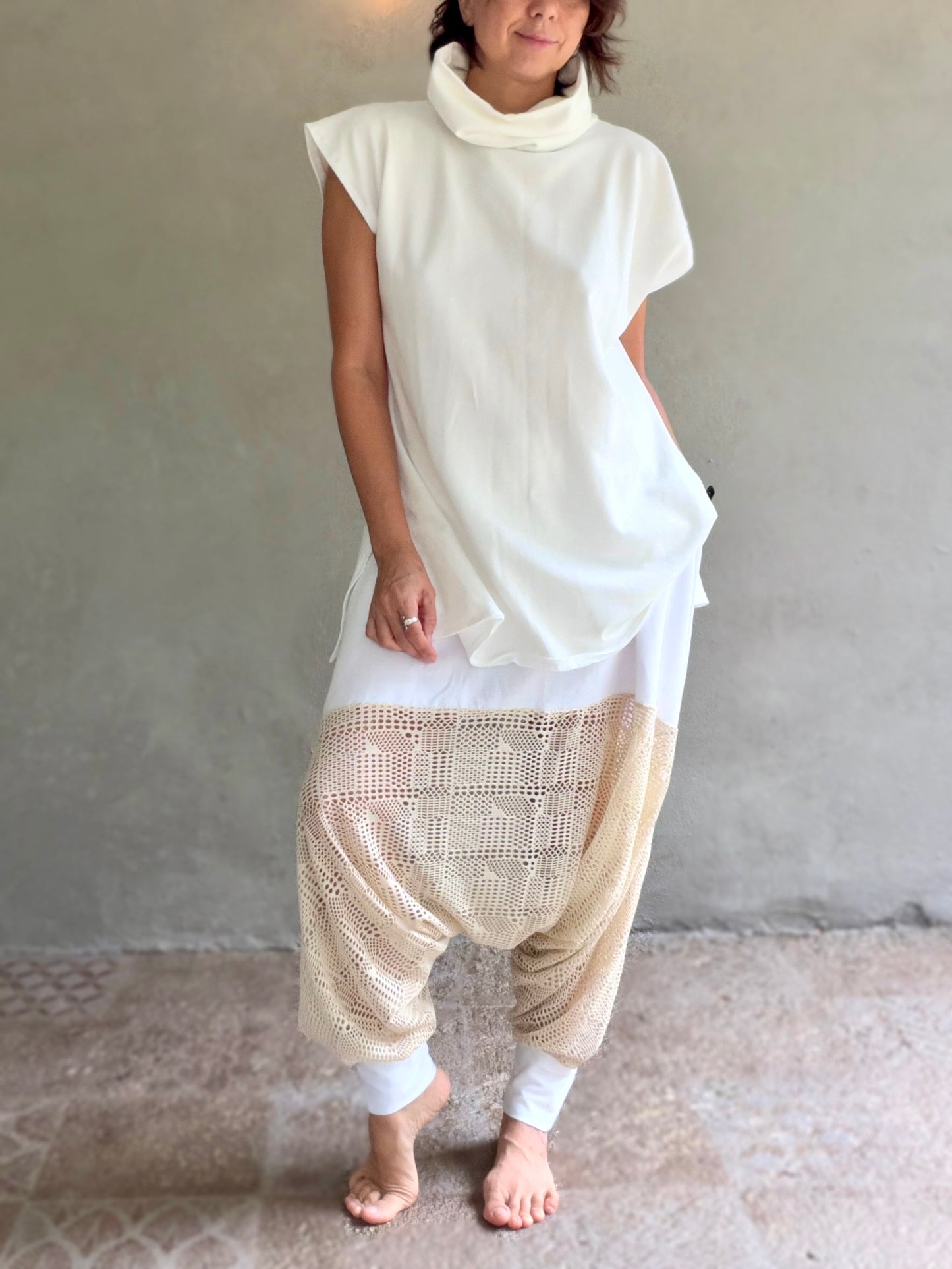 Female model wearing glorka white top with turtle neck