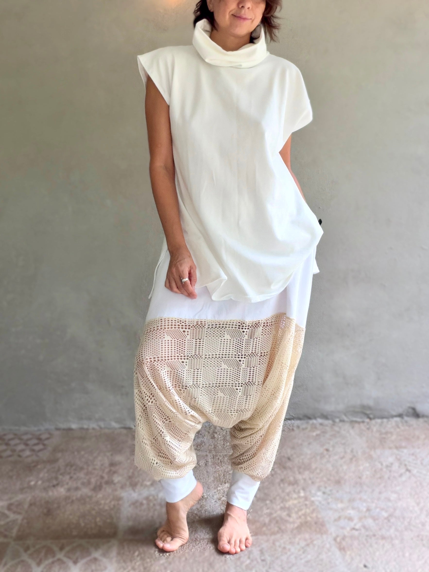 Female model wearing glorka white top with turtle neck