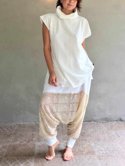 Female model wearing glorka white top with turtle neck