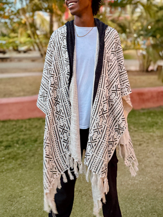 a man standing in glorka handblock printed poncho with dark gray hood