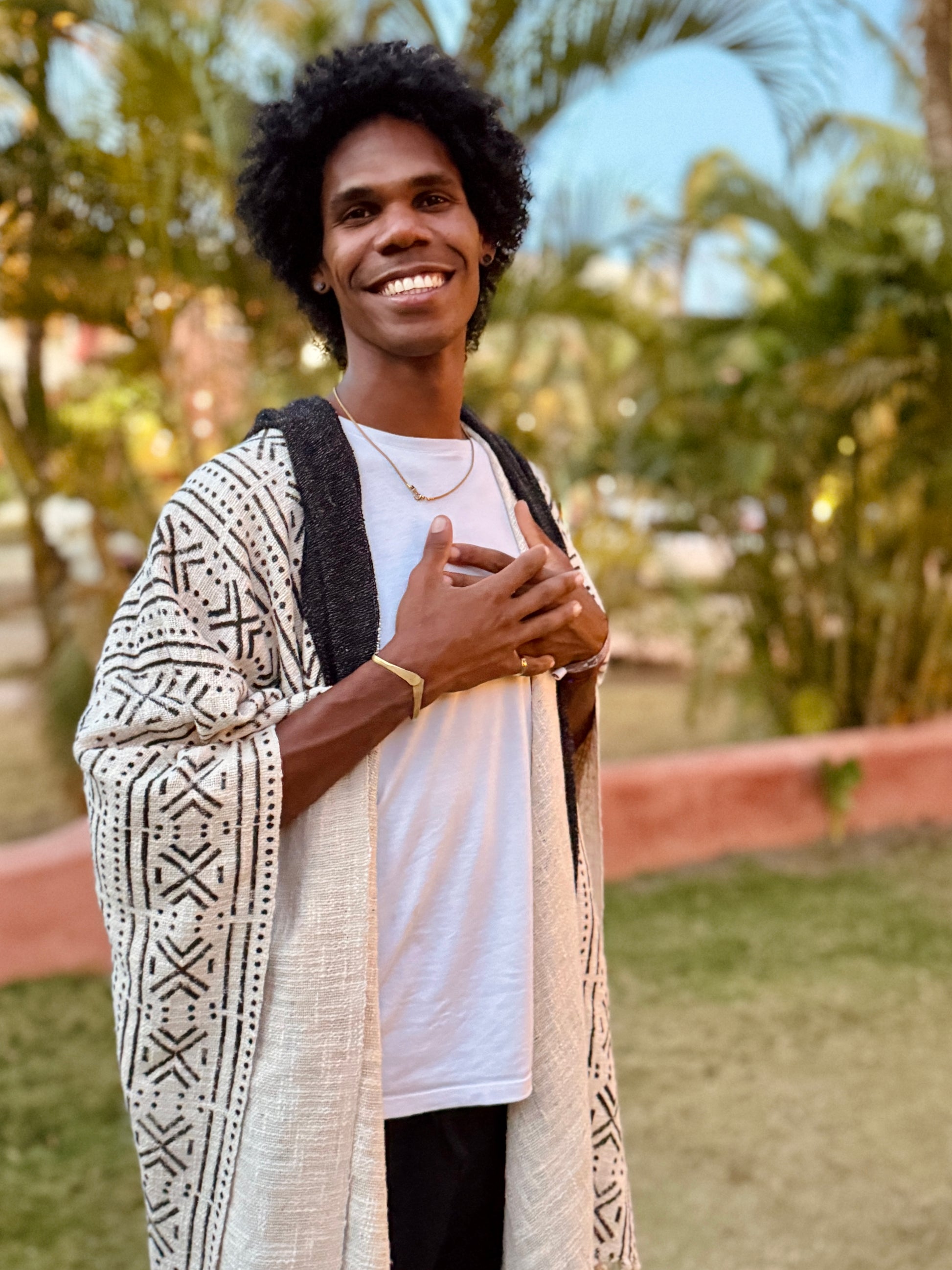 a man standing in glorka handblock printed poncho with dark gray hood