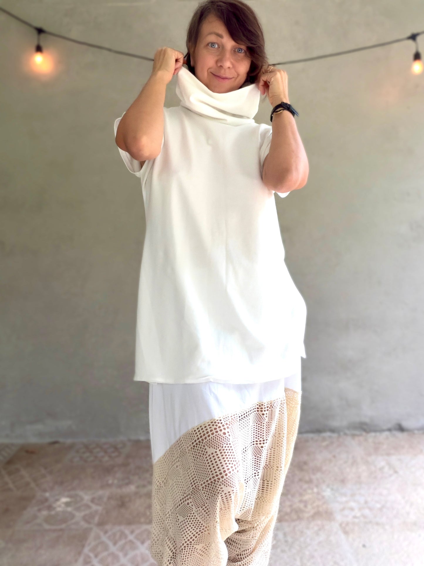 Female model wearing glorka white top with turtle neck