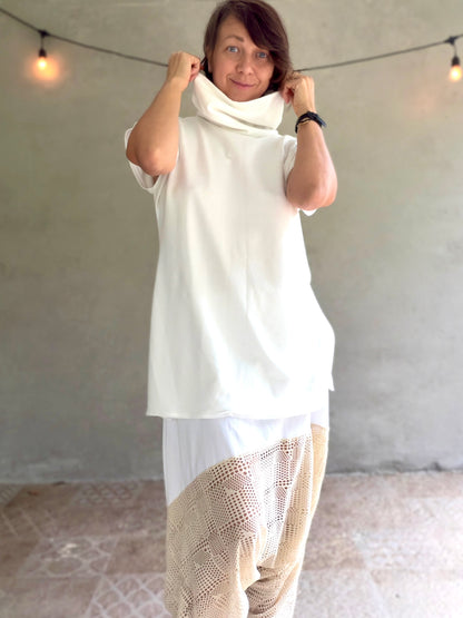 Female model wearing glorka white top with turtle neck