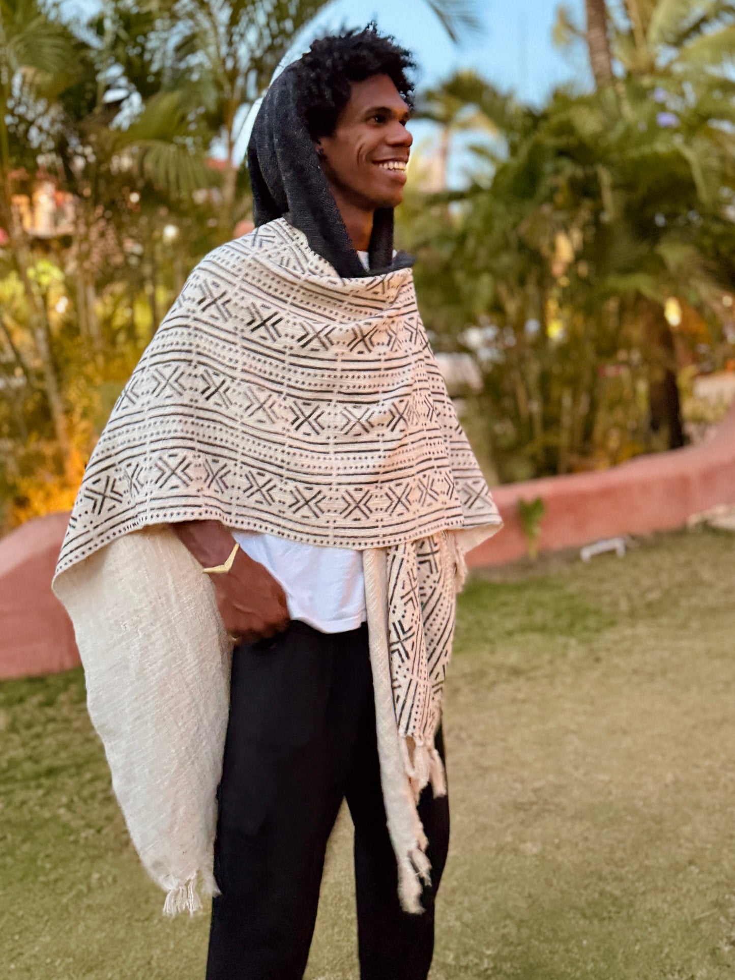 a man standing in glorka handblock printed poncho with dark gray hood