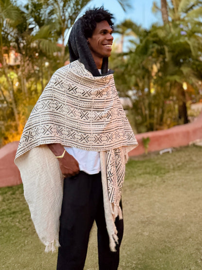 a man standing in glorka handblock printed poncho with dark gray hood