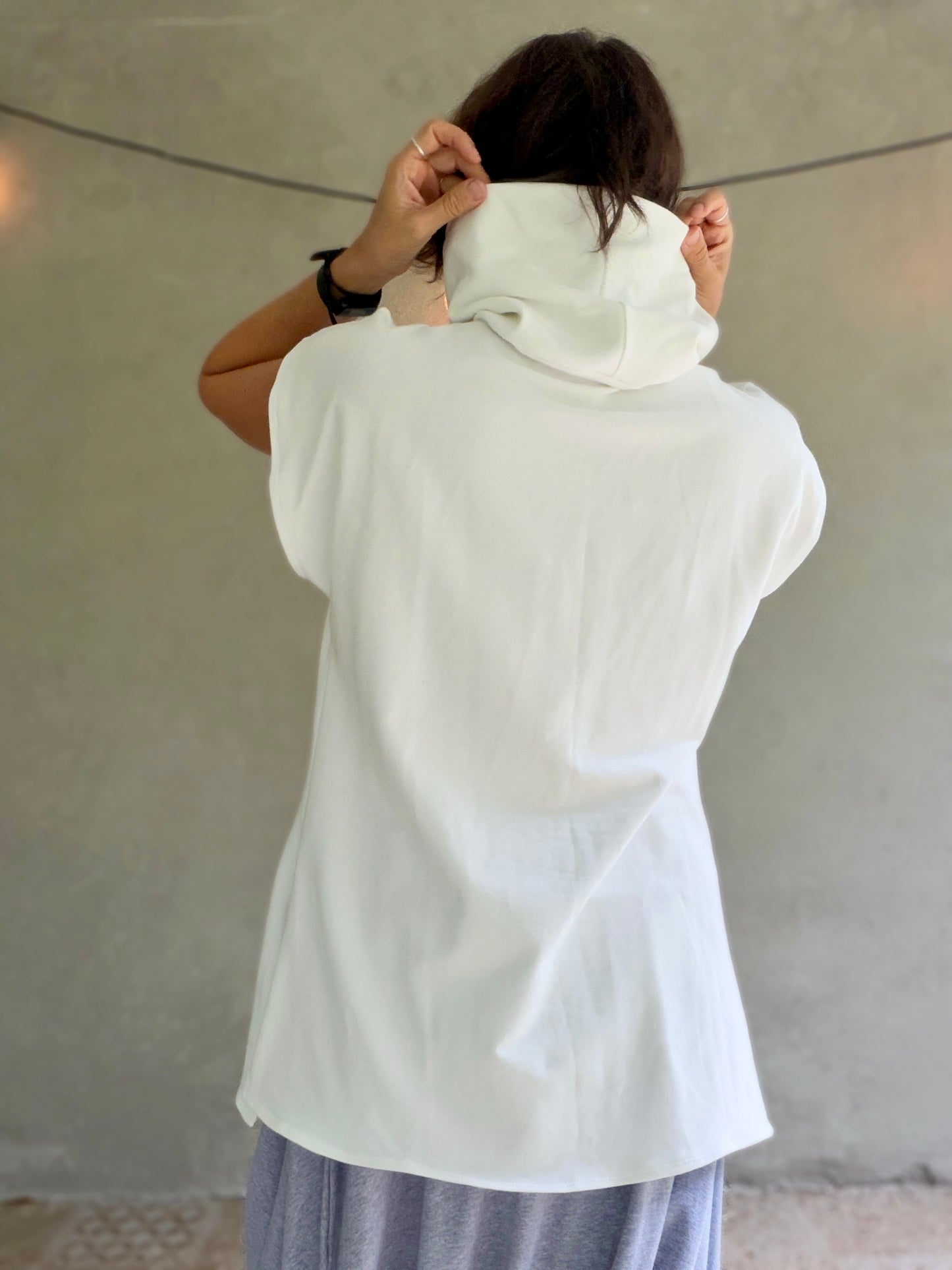 Female model wearing glorka white top with turtle neck