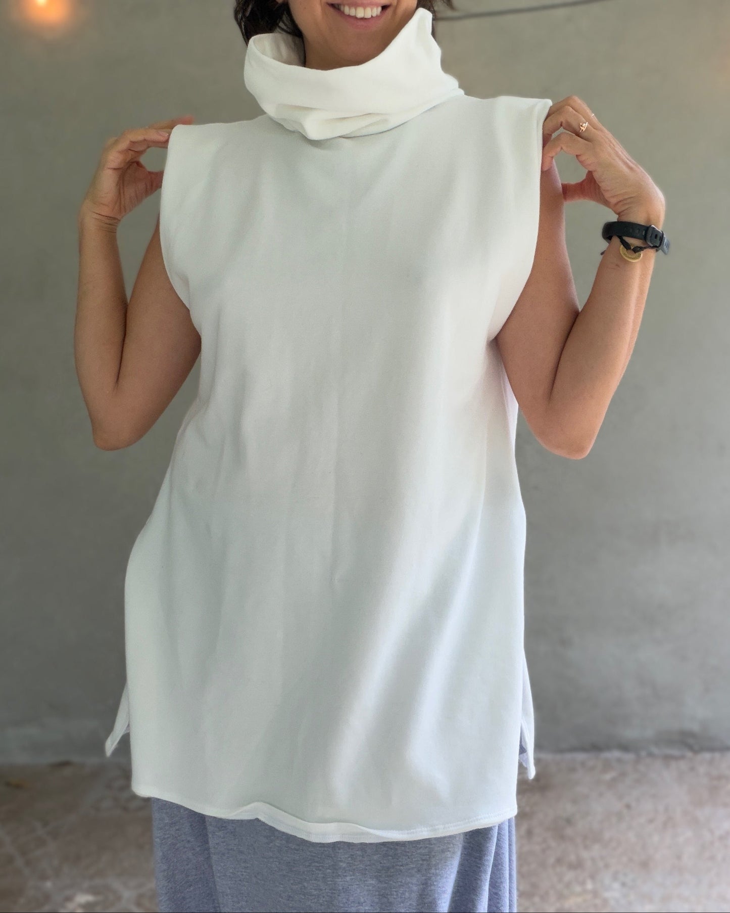 Female model wearing glorka white top with turtle neck