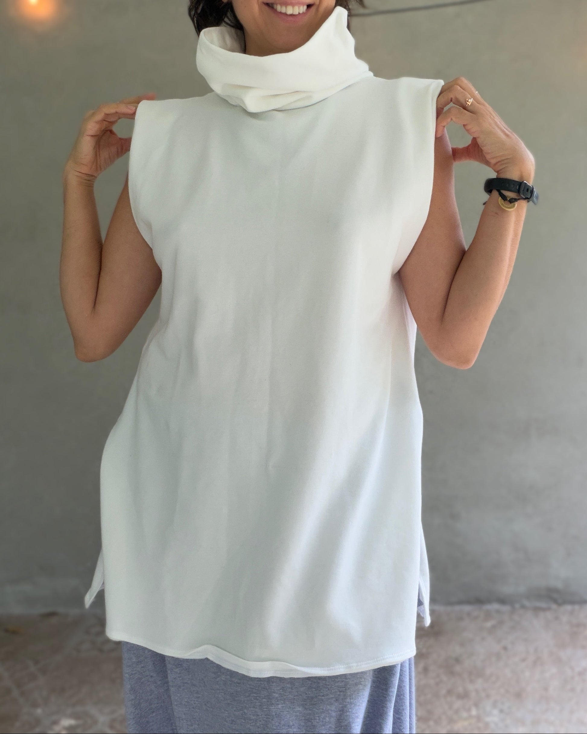 Female model wearing glorka white top with turtle neck