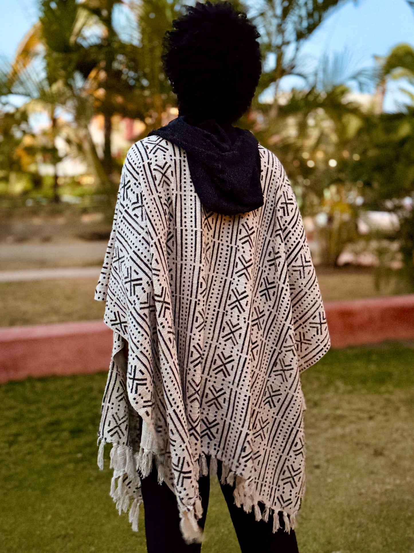 a man standing in glorka handblock printed poncho with dark gray hood