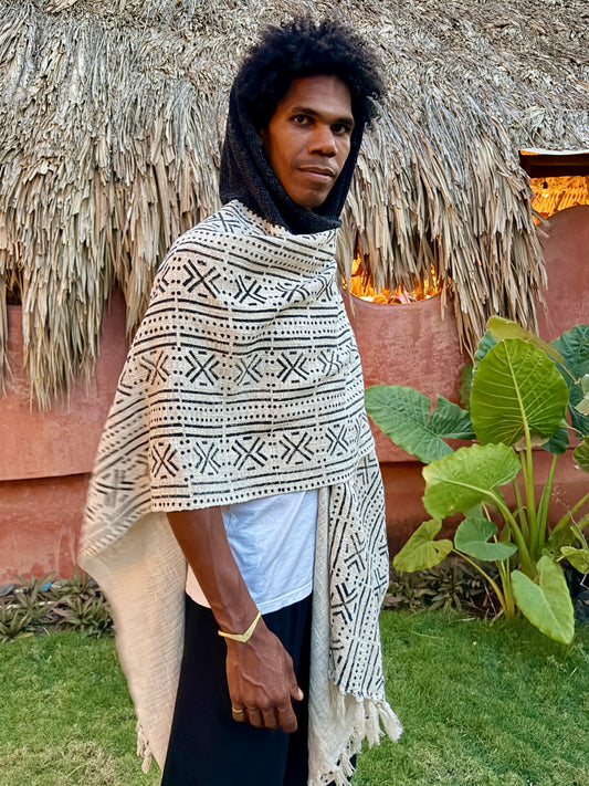 a man standing in glorka handblock printed poncho with dark gray hood