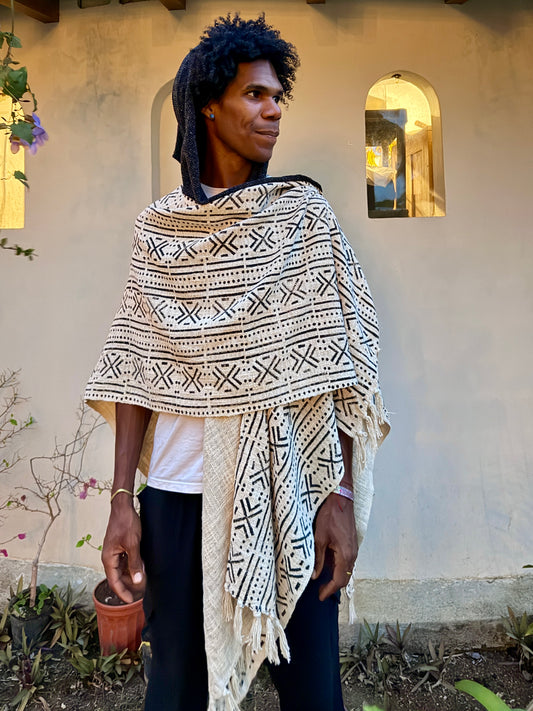 a man standing in glorka handblock printed poncho with dark gray hood
