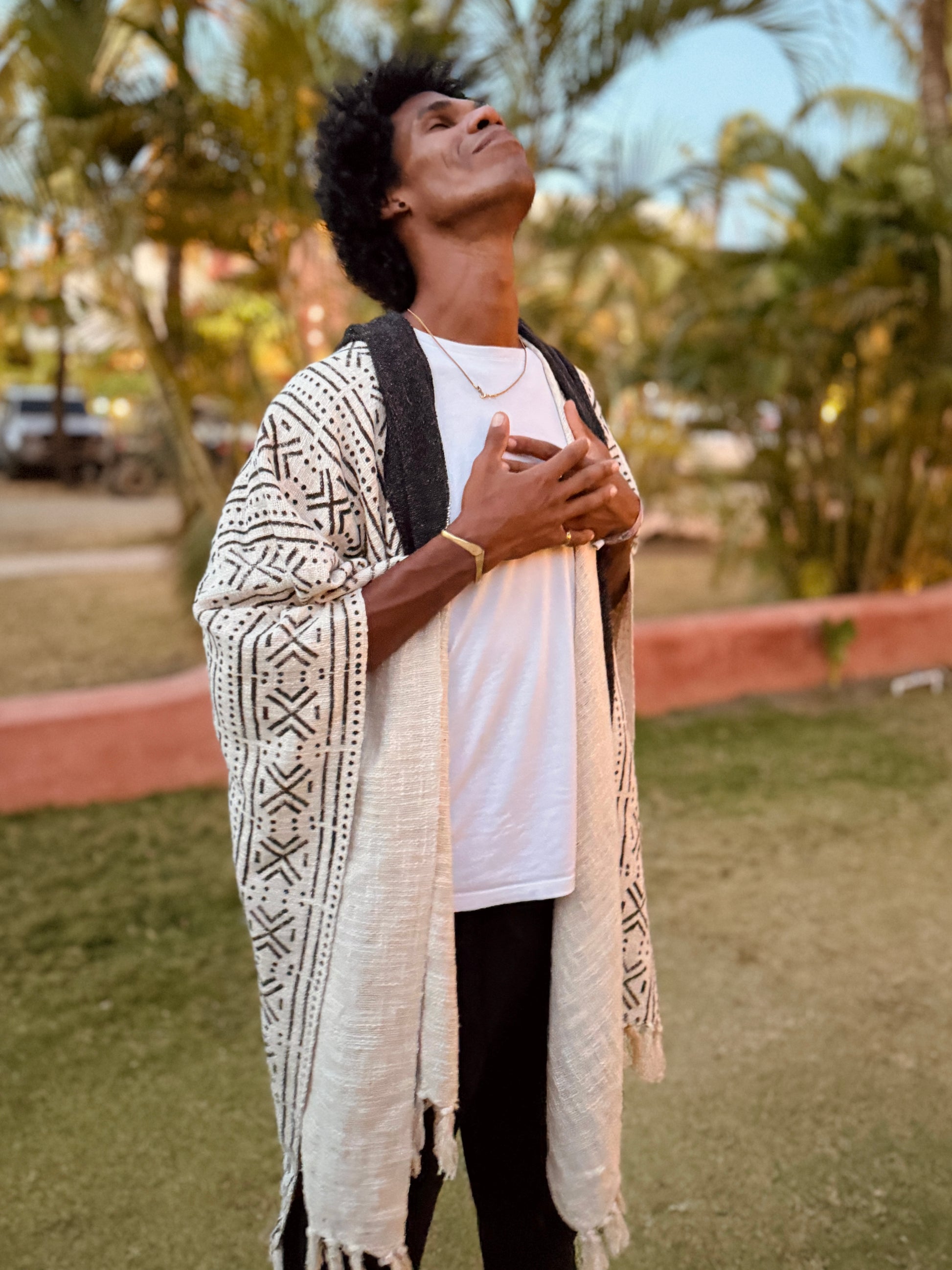 a man standing in glorka handblock printed poncho with dark gray hood
