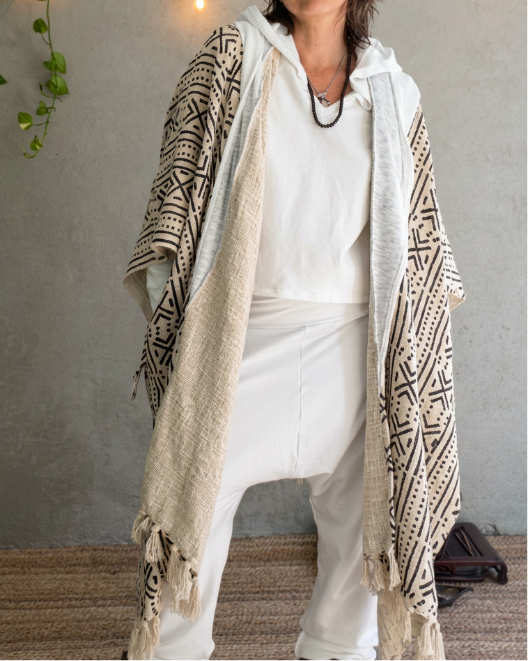 a woman standing in glorka handblock printed poncho with white hood