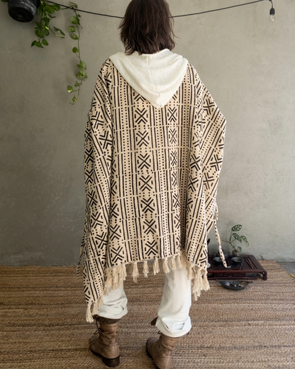 a woman standing in glorka handblock printed poncho with white hood